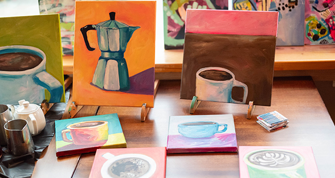 Paintings of coffee pots and cups arranged on a table.