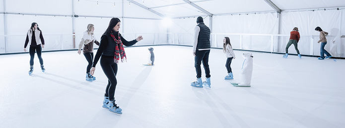 family ice skating together in north bend, oregon